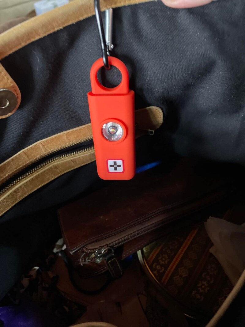 Emergency ID Australia Personal Alarms with light on inside of bag