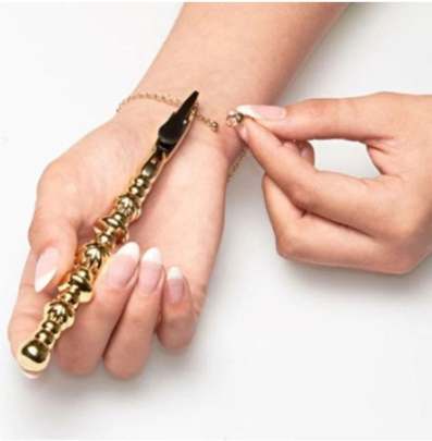 Gold Bracelet helper being used on bracelet